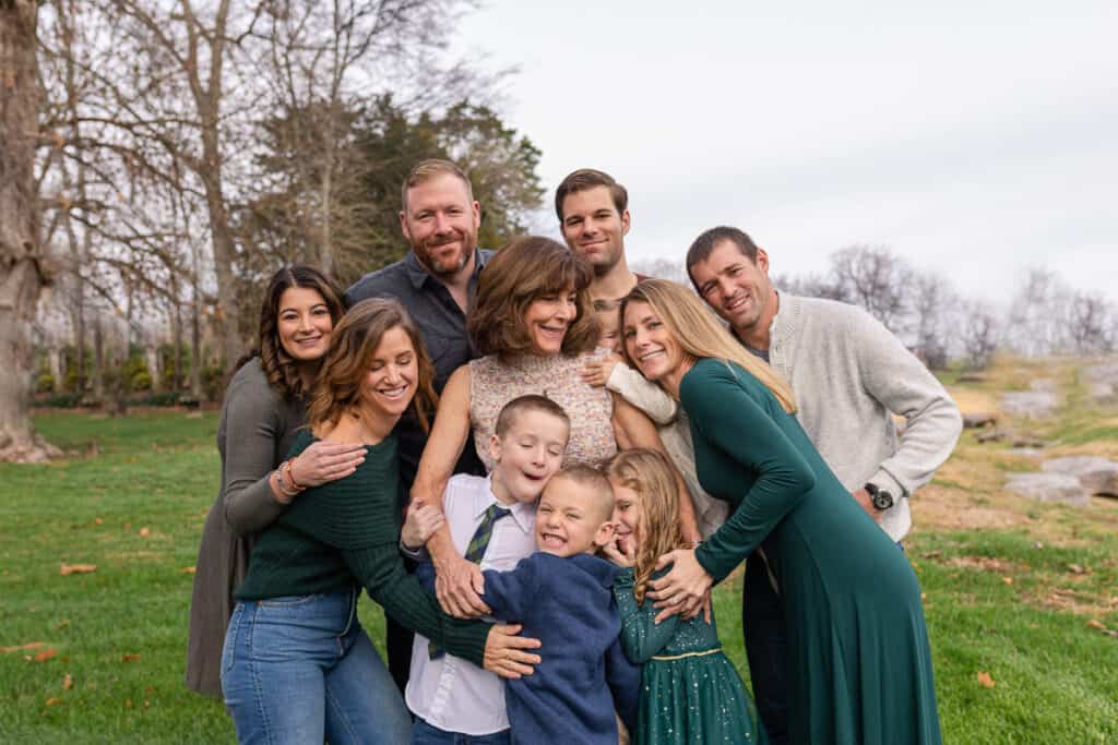 large family in a group hug outdoors